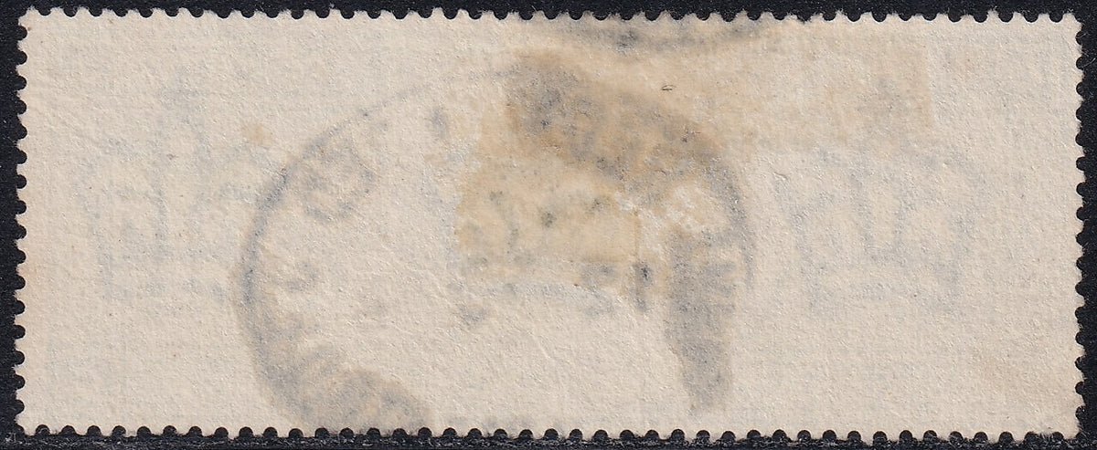 Reverse of the Great Britain 1891 £1 green JC stamp, showing the paper and perforations.